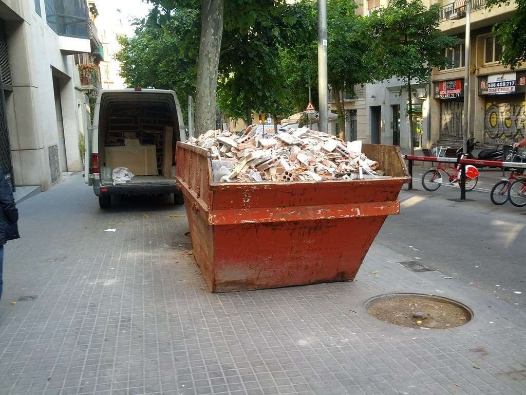 Construction-site skip filled with rubble and demolition debris