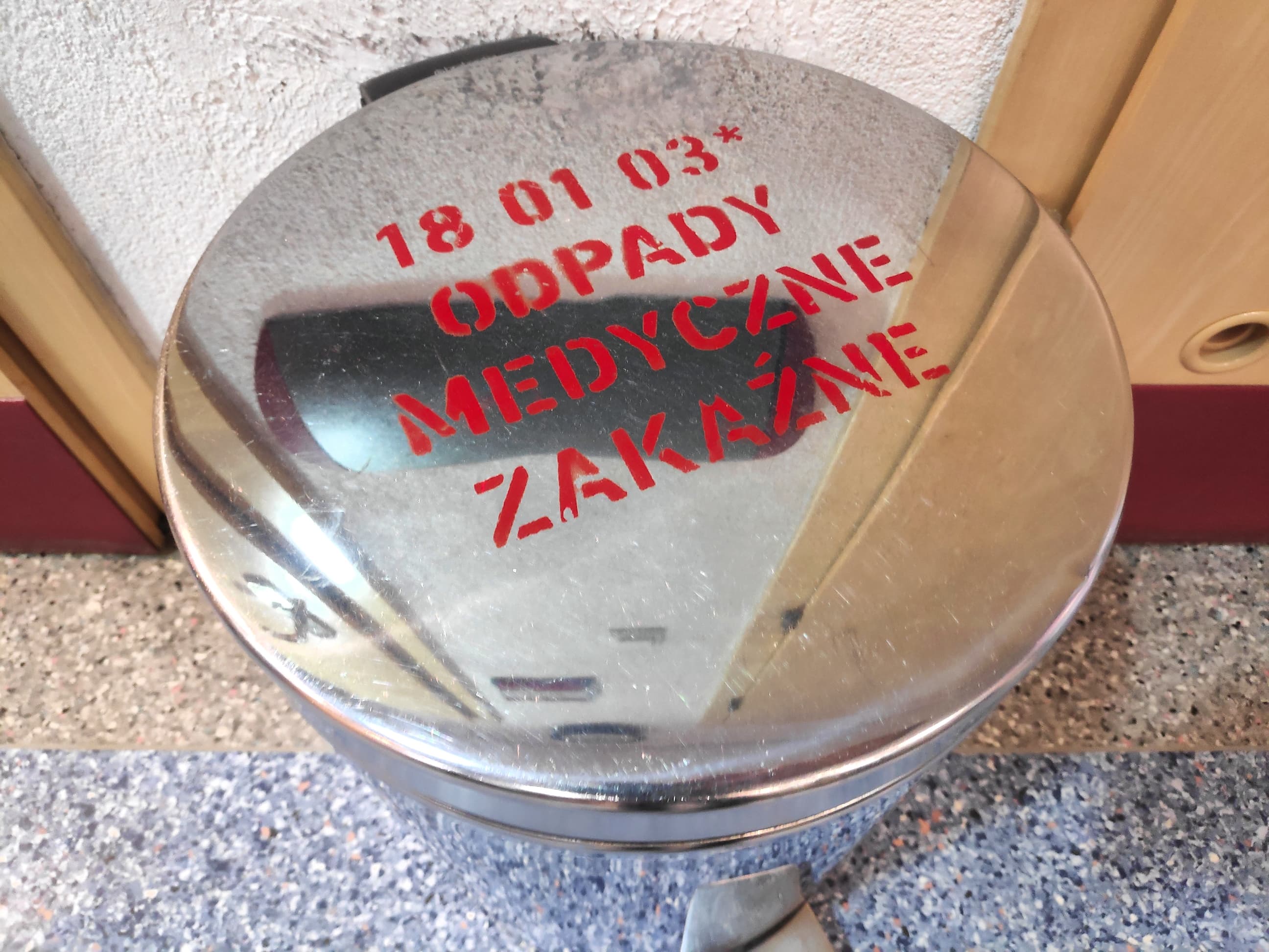 Stainless steel hospital bin labeled for infectious medical waste